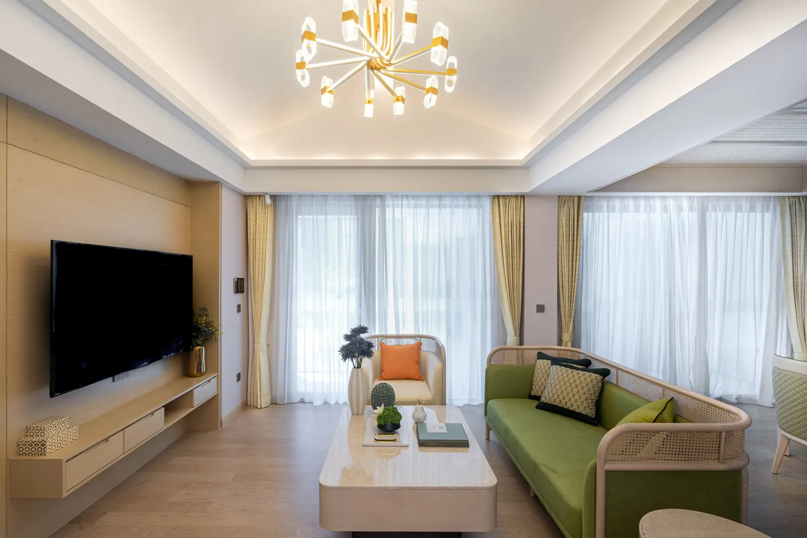 Layered living room lighting showing a ceiling flush-mount for ambient light, an arc floor lamp beside an armchair for task light, and a wall sconce providing accent light