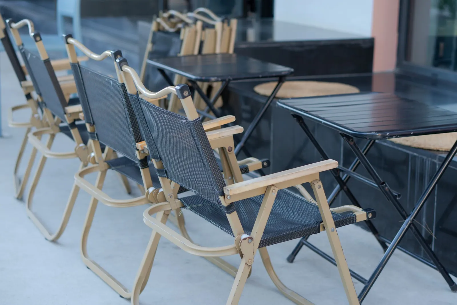 Cushioned chaise lounger beside a modular sectional sofa on a sunny backyard deck