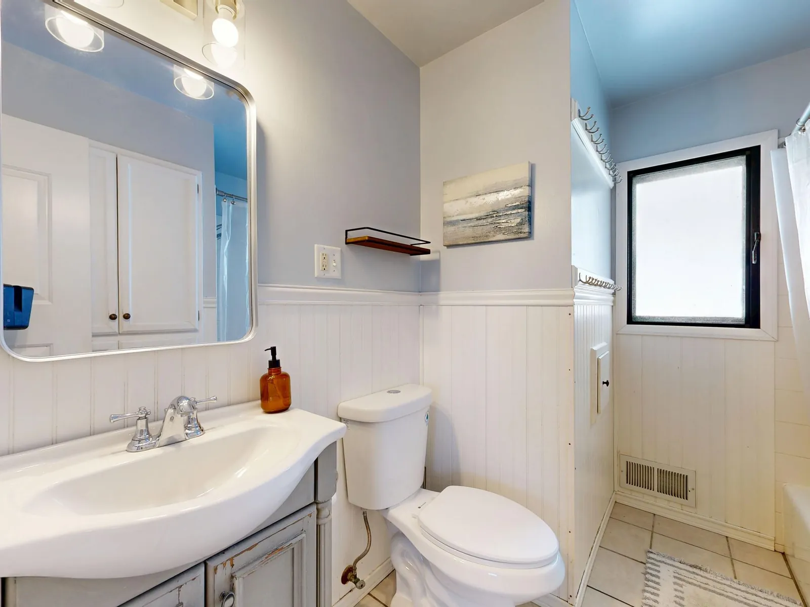 Freshly painted bathroom wall in satin finish showing smooth, moisture-resistant surface near tub surround