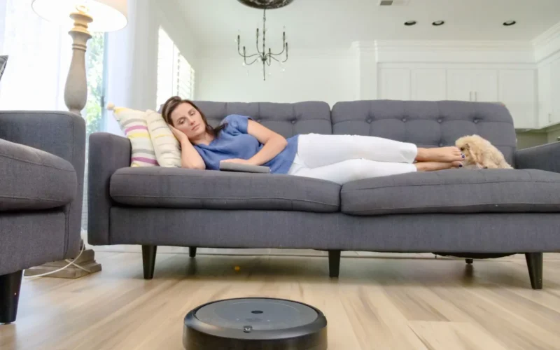 Rubber roller brush on a robot vacuum lifting embedded pet hair from medium-pile carpet