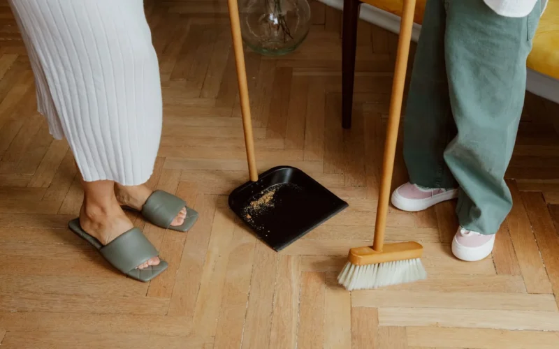 A parent and child loading the dishwasher together during a 5-minute morning kitchen reset