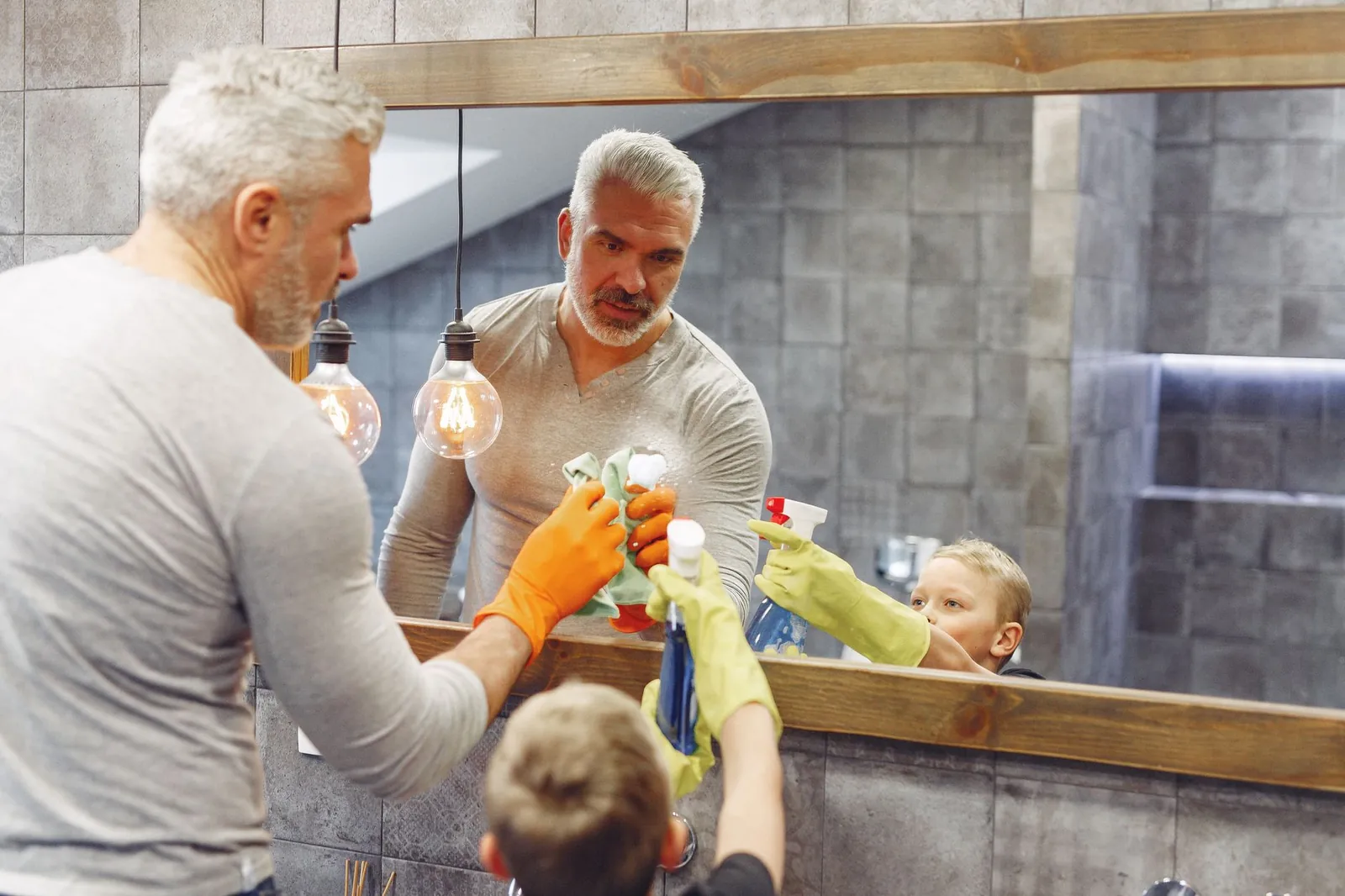 A parent and child loading the dishwasher together during a 5-minute morning kitchen reset