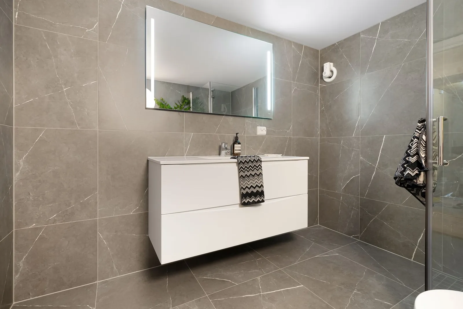Baking soda paste applied to bathroom grout lines with a small scrub brush