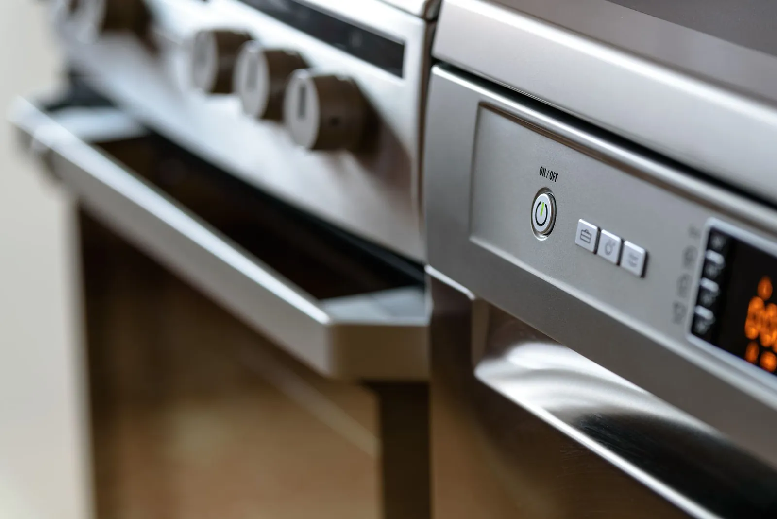 Baking soda paste spread across the interior base and sides of a home oven before the vinegar spray step