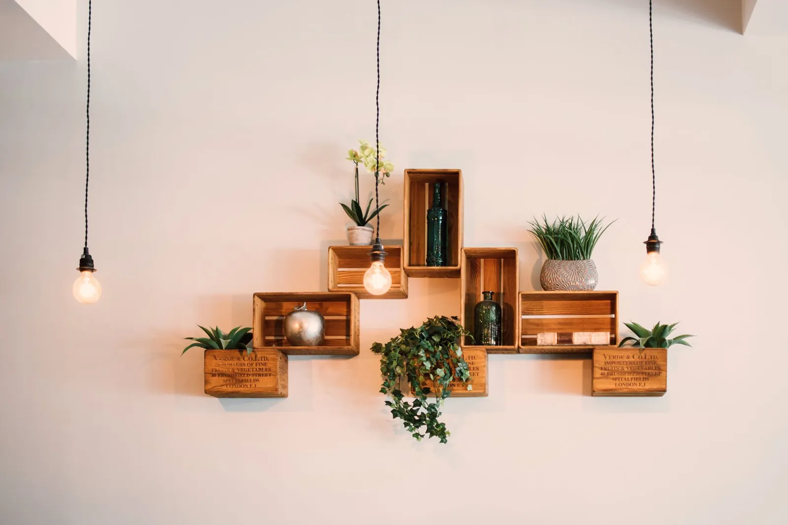 Stud finder marking wall stud locations at shelf height before bracket installation