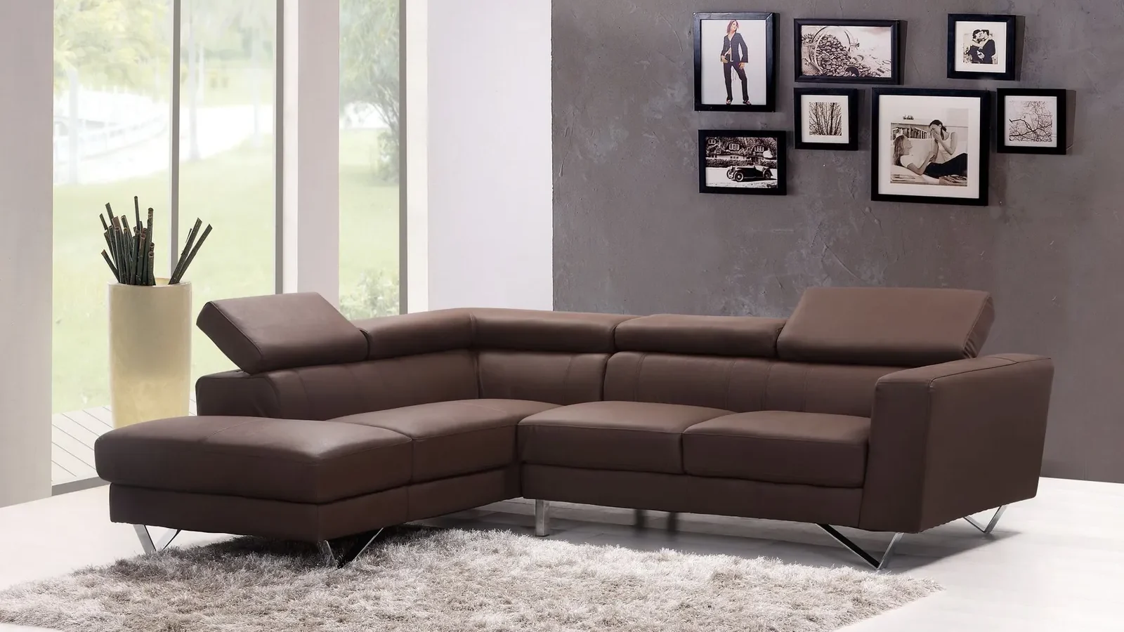 A standard three-seat sofa against the wall of a compact living room, with a narrow side table and floor lamp showing the clearance around it