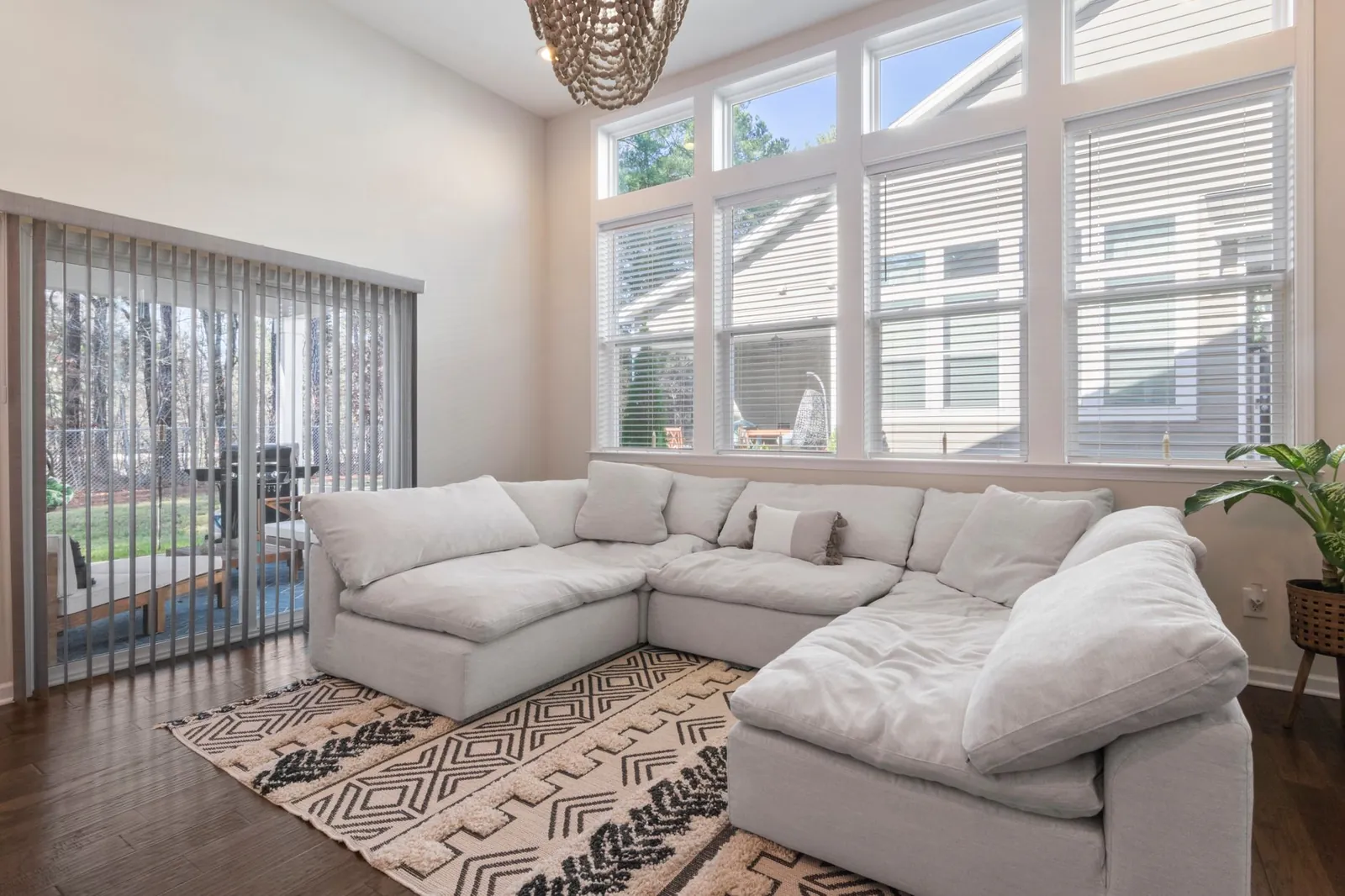 An L-shaped sectional filling a large living room corner, with visible seat depth and chaise length to show scale against the room