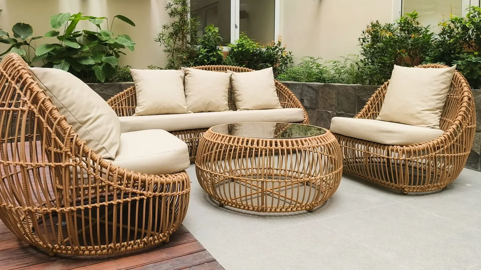 Composite decking boards in charcoal gray installed on a backyard patio, showing realistic wood-grain texture up close